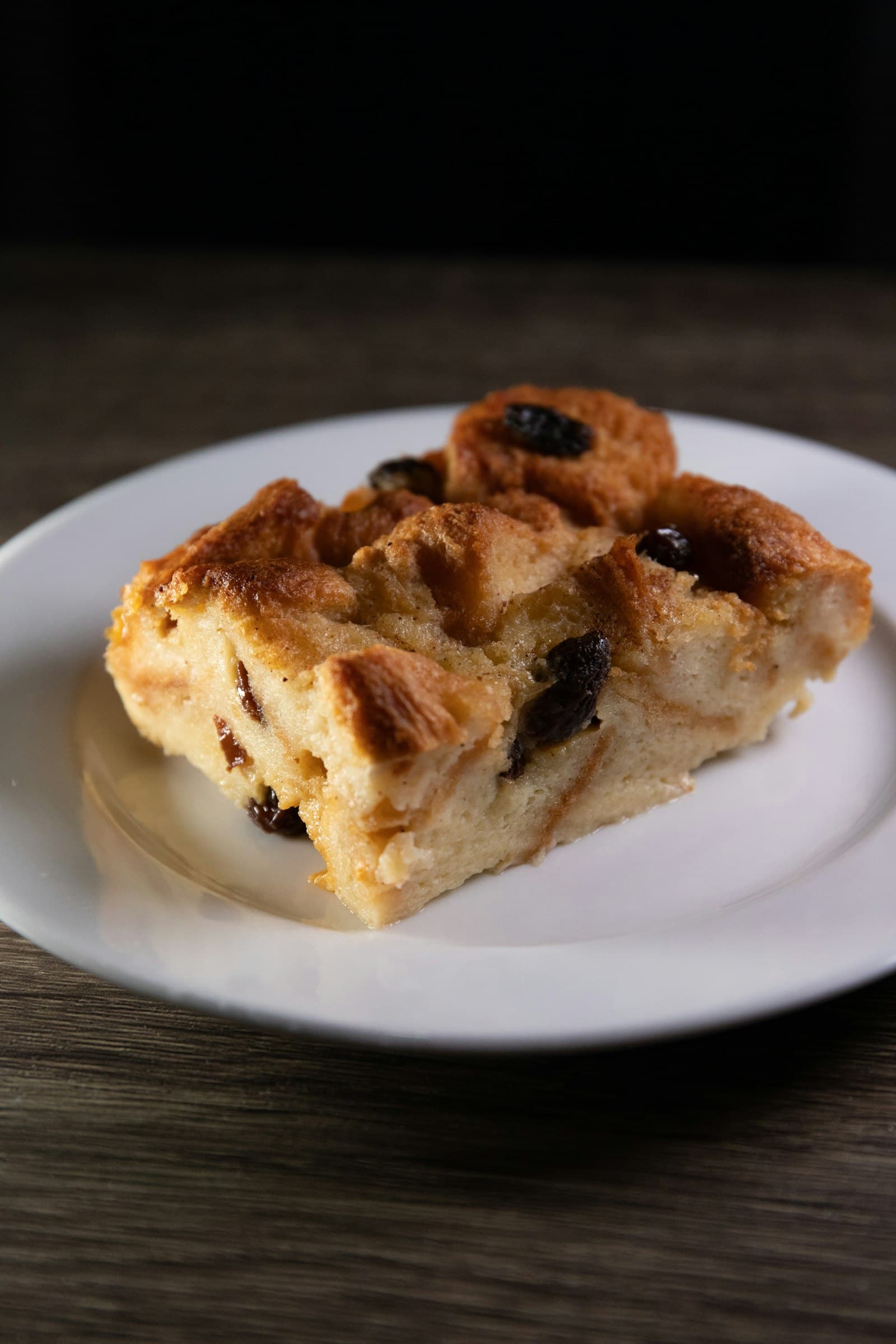 A golden baked pastry pudding on a white plate